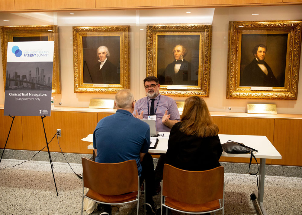 Summit attendees meet with a clinical trial navigator. Photo by Hannah Cohen.